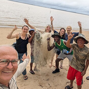 Diverse group fishing net beach selfie