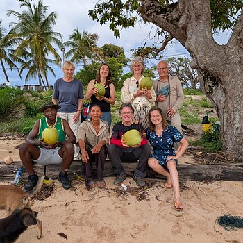 Group holding coconuts on suriname trip suriquest