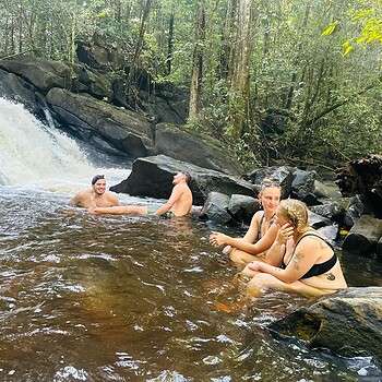 People swimming waterfall forest 2026 05