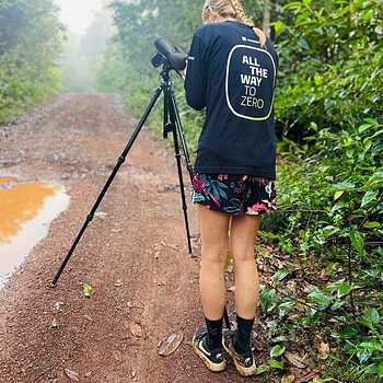Photo person spotting scope forest road 2026 05