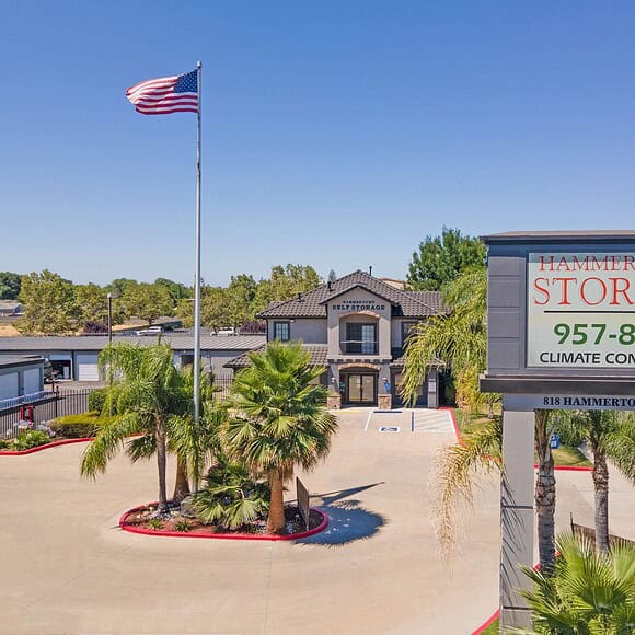 A high-quality image of the front of Hammertown Self Storage in Stockton, CA. The facility's entrance is clean and well-maintained, featuring a prominently displayed sign with the business name and logo.