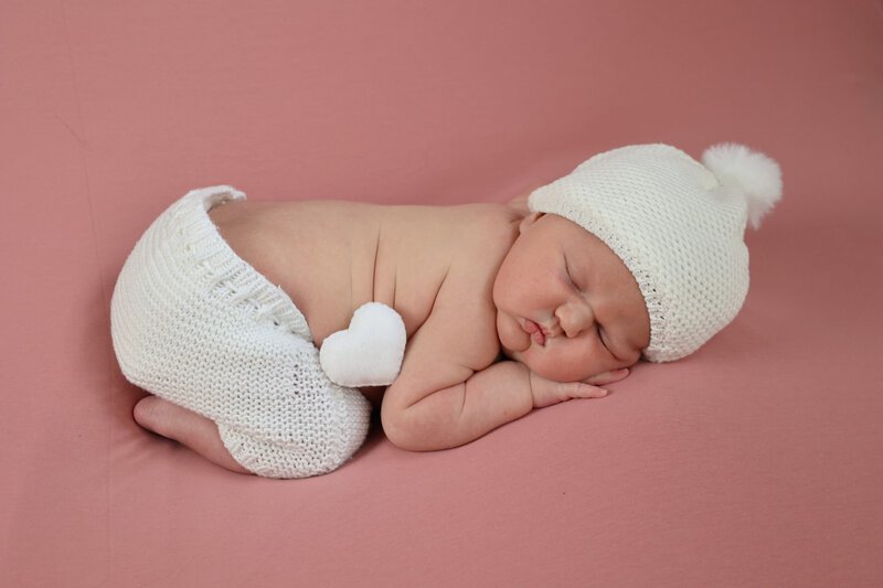photographe naissance Rhône fille fond rose cœur blanc