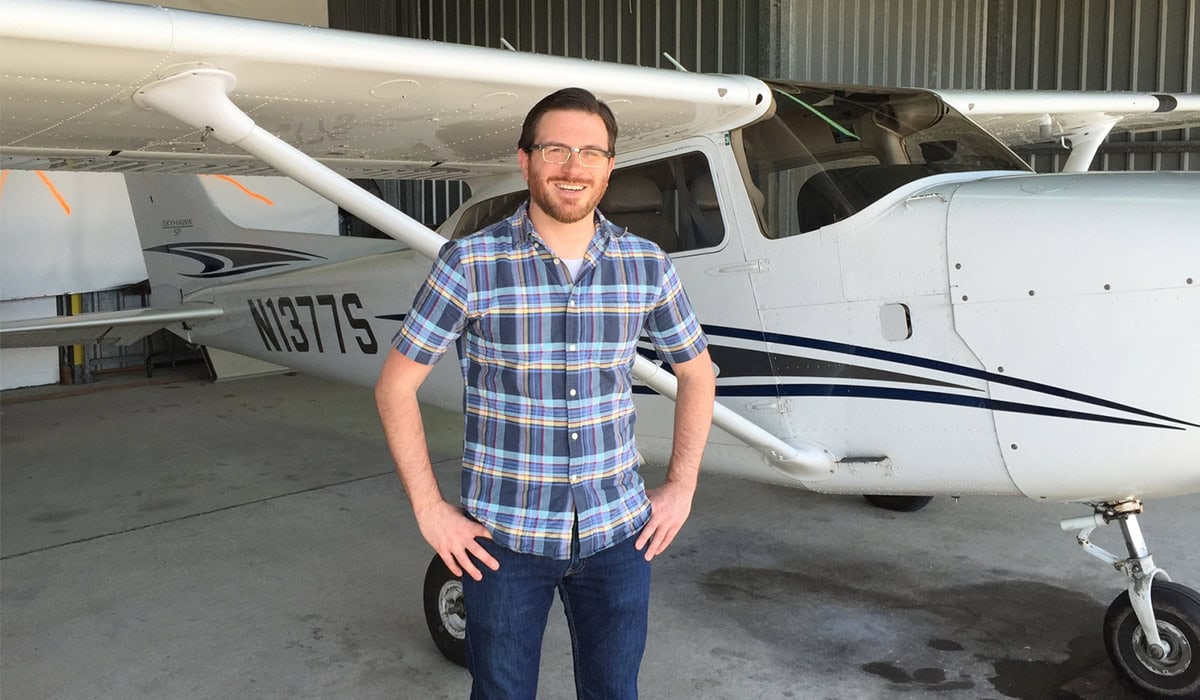 Jason DeCamillis in front of a plane