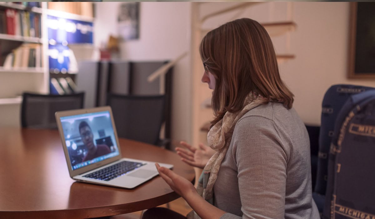 Woman video-chatting with someone on a computer