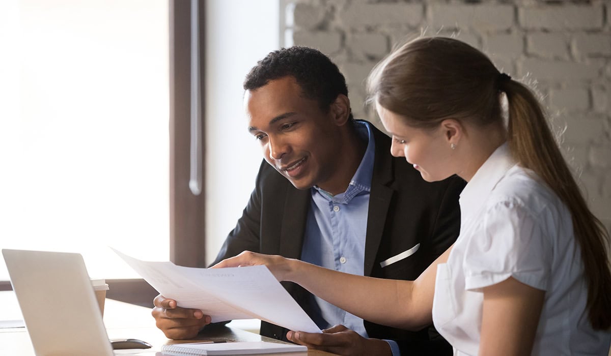 Female Financial Advisor Insurer Consulting Male African American Client About Contract