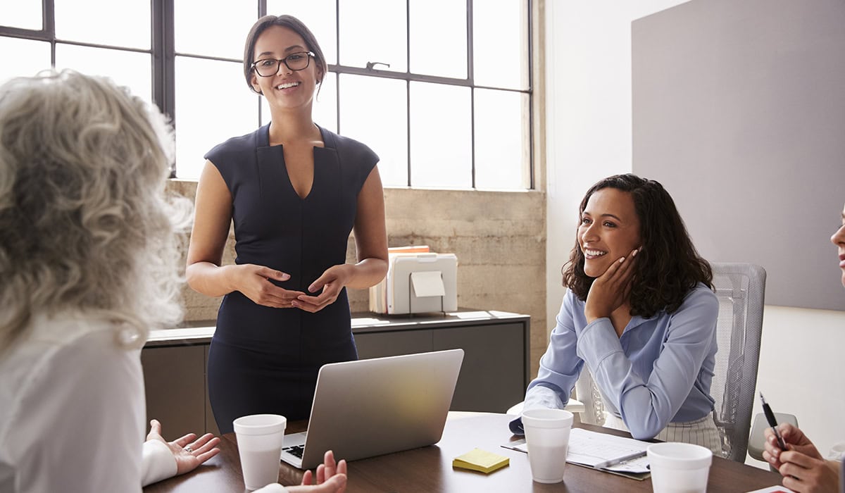 Female Manager In Glasses Addressing Businesswomen In Meeting