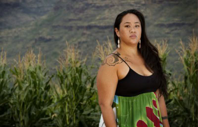 Malia Chun stands in front of the GE corn fields near her home. Source: MIKE COOTS FOR EARTHJUSTICE