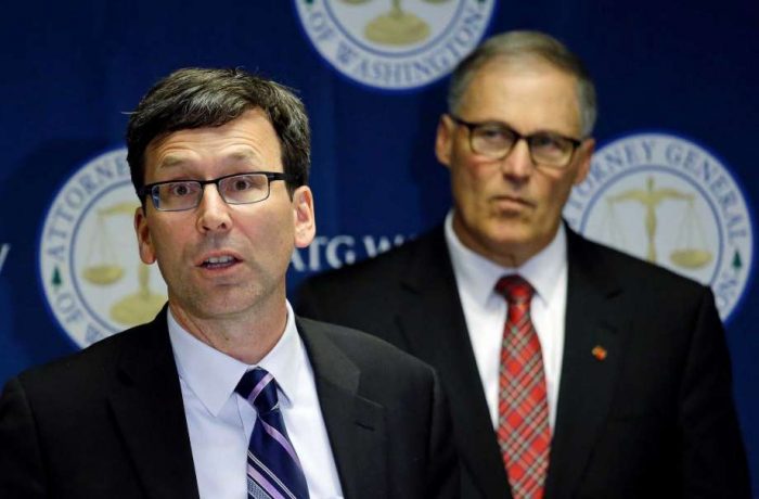 Washington Attorney General Bob Ferguson, left, speaks as Gov. Jay Inslee looks on during a news conference where the lawsuit was announced. Source: Houston Chronicle