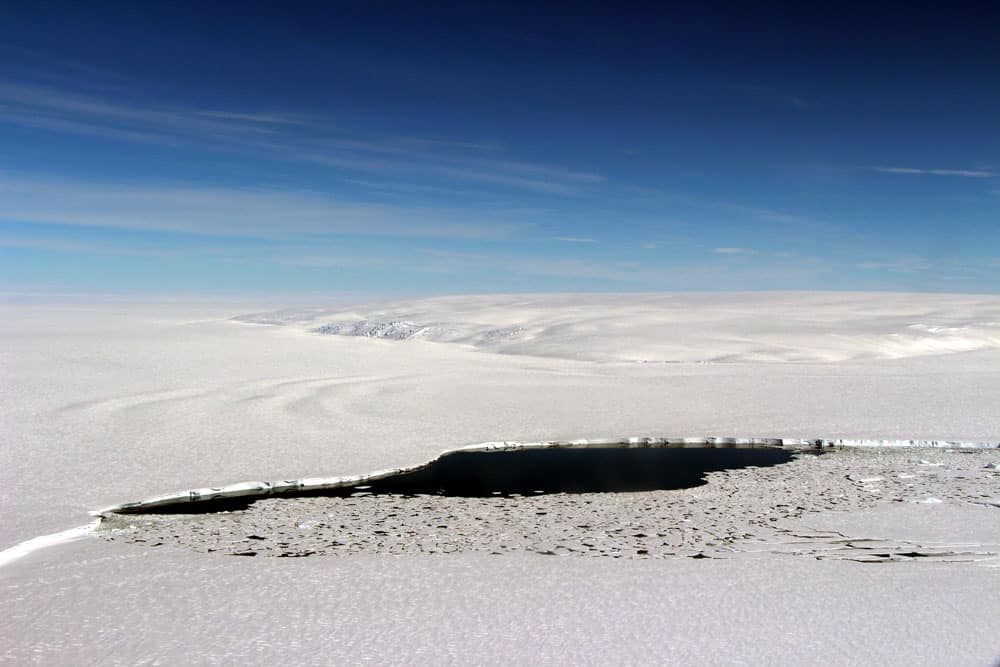 A polynya that has formed in an embayment where the Venable Ice Shelf meets Farwell Island in Antartica. Photo: John Sonntag/NASA, public domain.