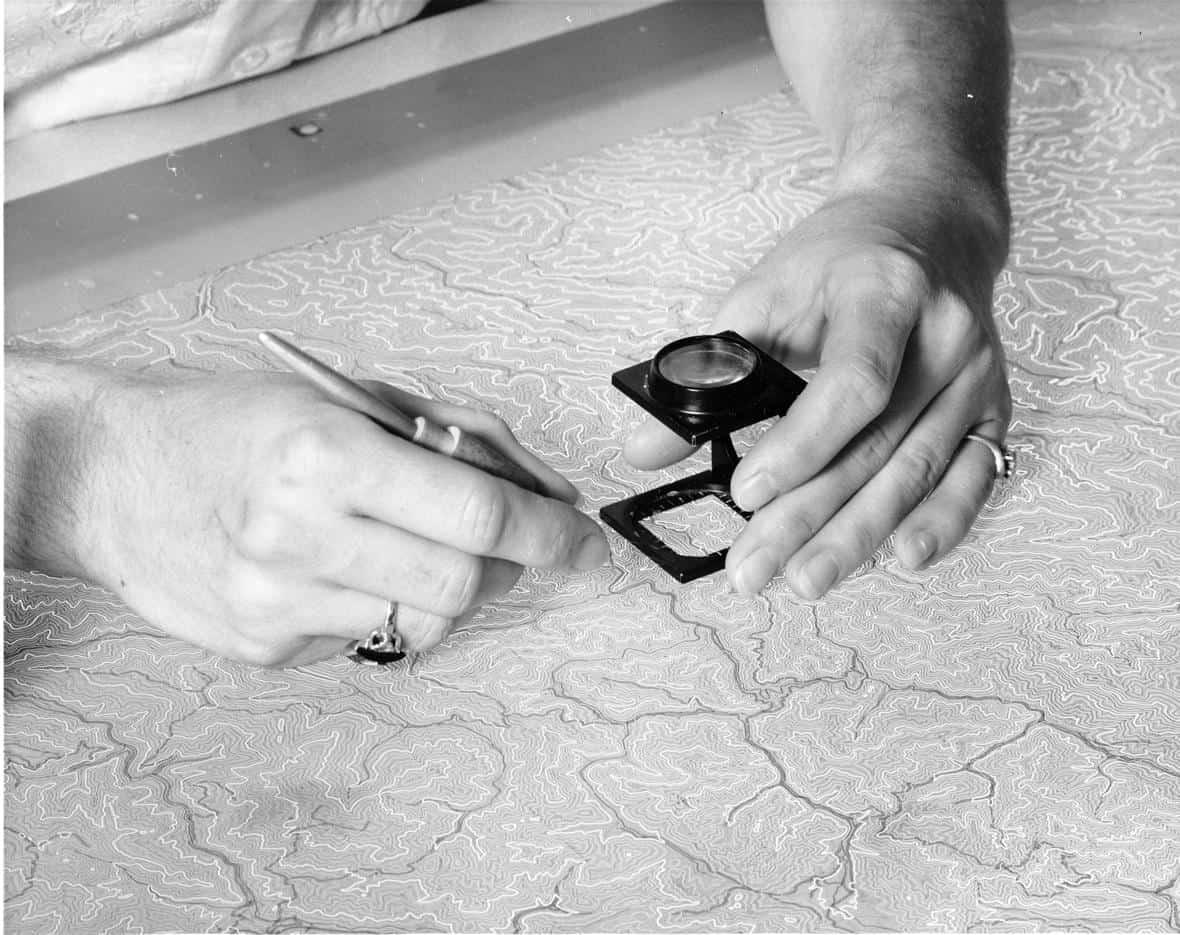 Before the use of computer cartography, mapmaking was a manual process. Scribing of the intermediate contours for a USGS topographic map using a freehand scriber in 1957. Photo: U.S. Geological Survey. Public domain.