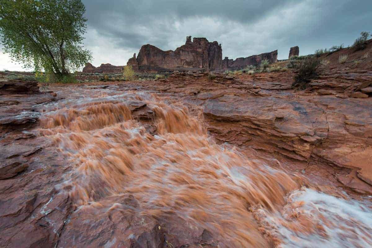 Flash flooding can move soils and wear away bedrock, causing erosion. Runoff after a storm in the lower Park Avenue area of Arches National Park, Utah. NPS photo, public domain.