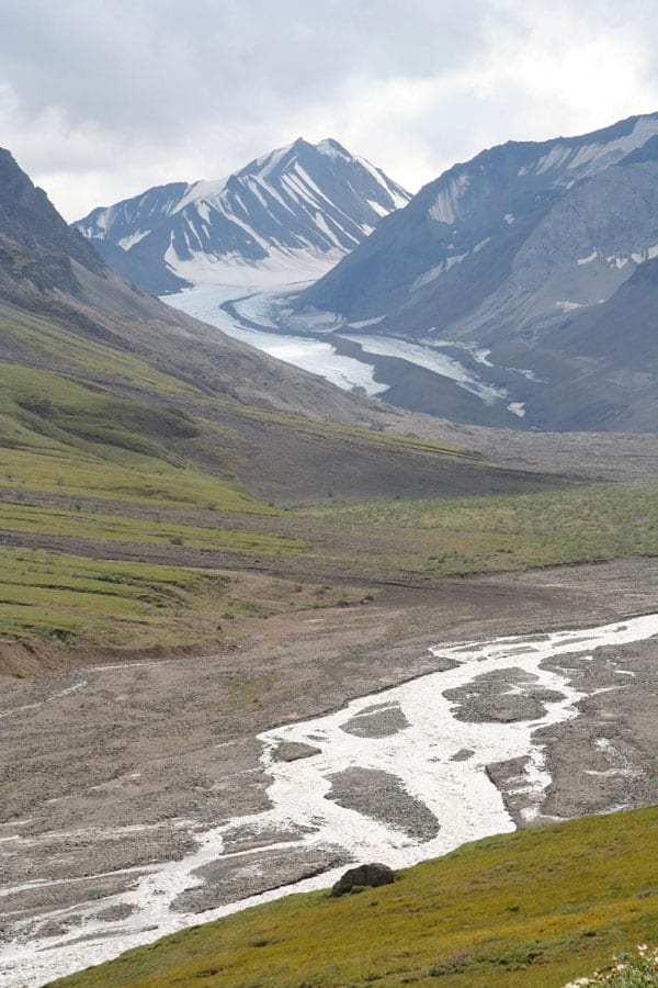 Retreating glacier south of Mt. Pendleton in Denali National Park, Alaska, with runoff from glacial melt seen in the foreground. Photo: Dennis G. Dye, U.S. Geological Survey. Public domain.