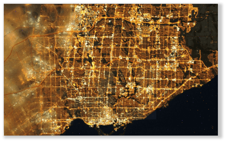 Aerial Image of the GTA, showing light pollution hotspots in white light. Major streets and Highways can clearly be identified.
