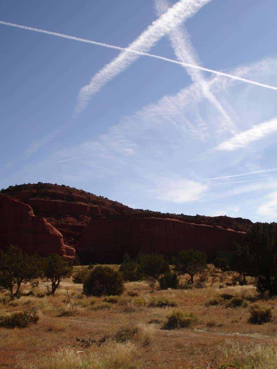 The Jemez Red Rocks at Walatowa, along with several contrails evident in the sky. Photo: Annette Olson, USGS. Public domain.