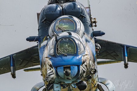 High-speed fighter jet aircraft with detailed cockpit and aerodynamic design, captured in flight against a cloudy sky.
