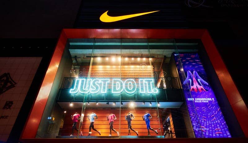 nike fashion shop logo sign front sports retail store sale window night 58836692