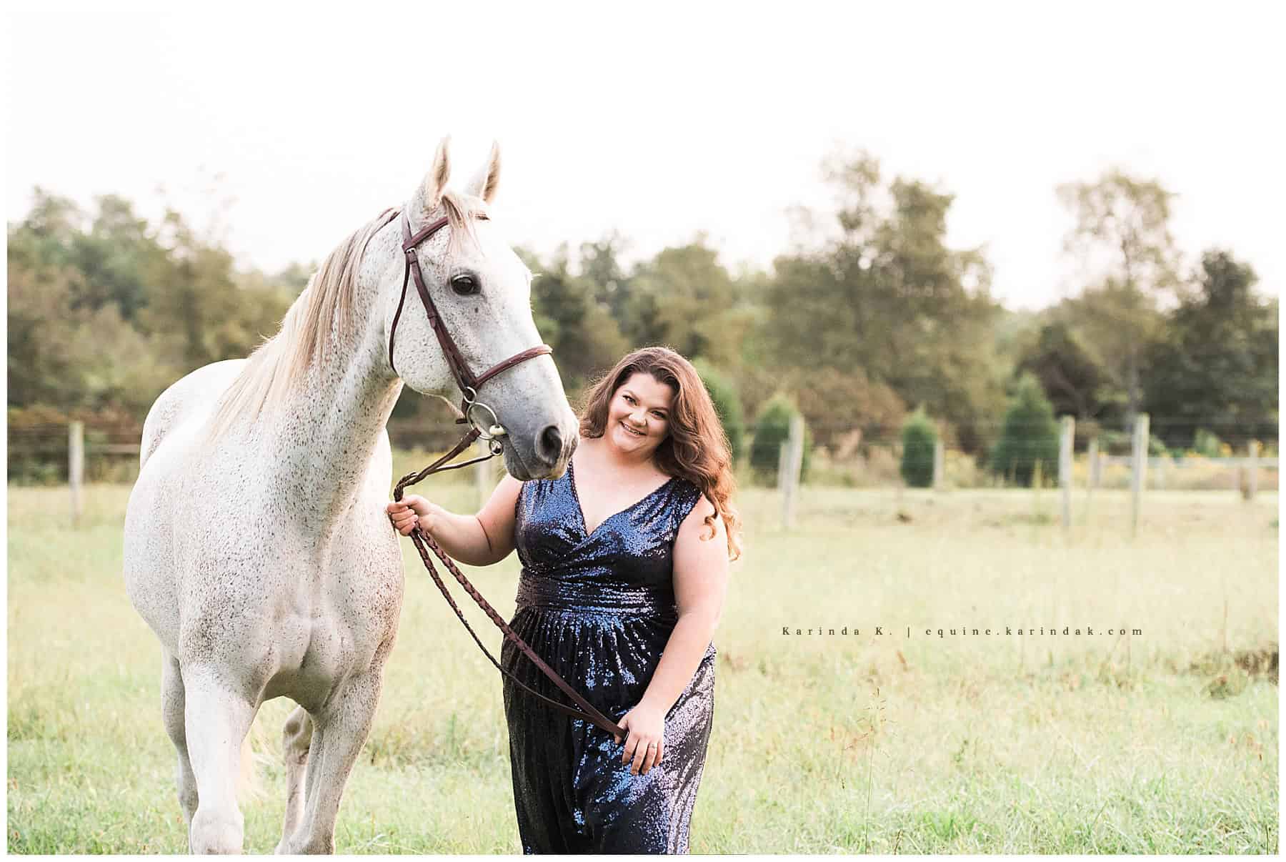horse and rider outdoor portrait in field wearing fancy dress