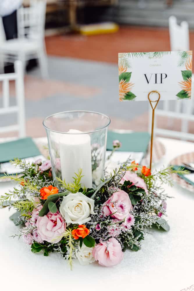 A beautiful VIP table setup with floral decorations and a candle centerpiece, perfect for exclusive events in Thailand.