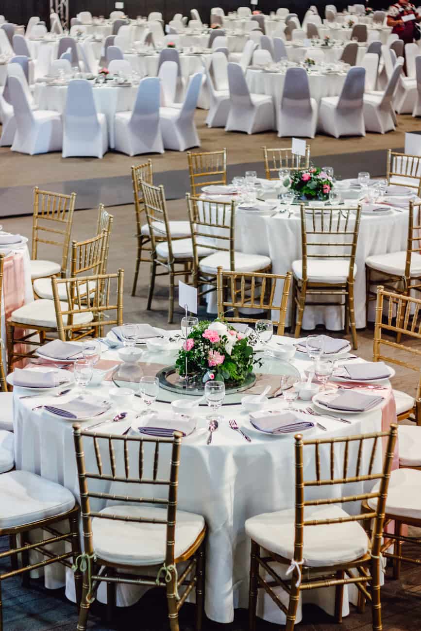 Crafted dining tables with floral arrangements for wedding events in Thailand, showcasing elegant banquet arrangements.