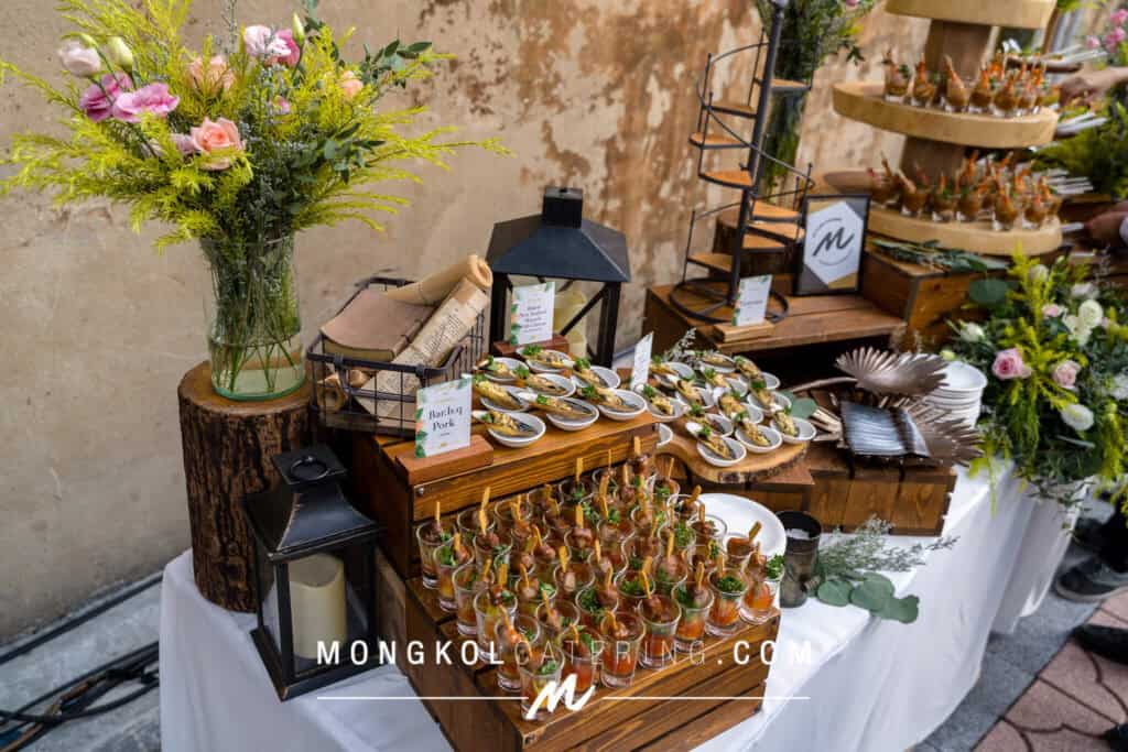 Elegant event catering setup with Thai-inspired appetizers and floral decor in Thailand.