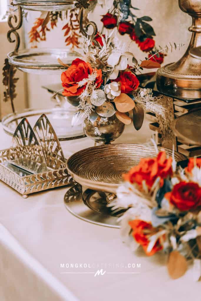 Elegant floral centerpiece with gold and silver tones for event catering in Bangkok, Thailand.