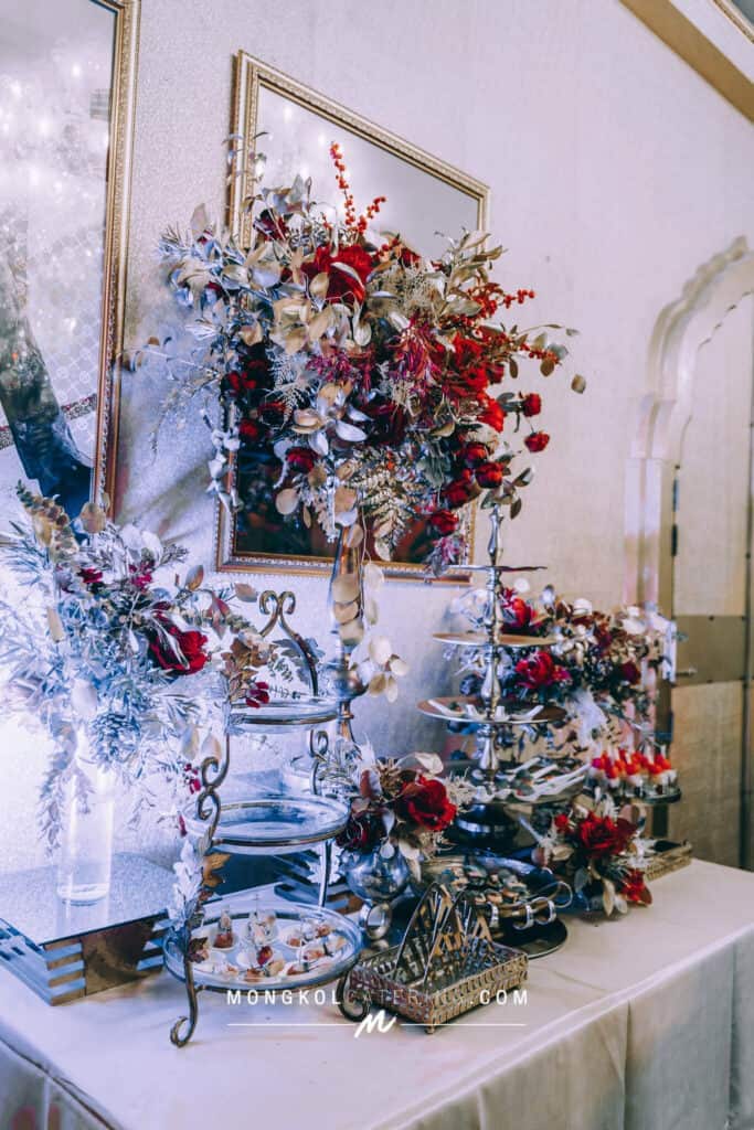 Elegant floral centerpiece with red and gold accents for event catering in Thailand.