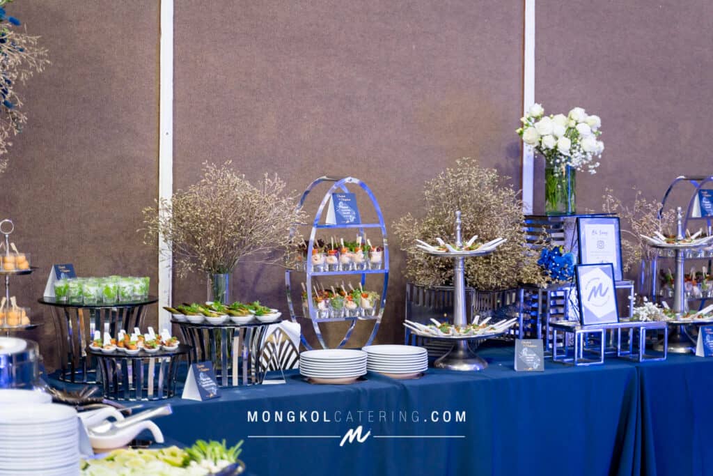 Elegant catering buffet setup with floral decor in Thailand.
