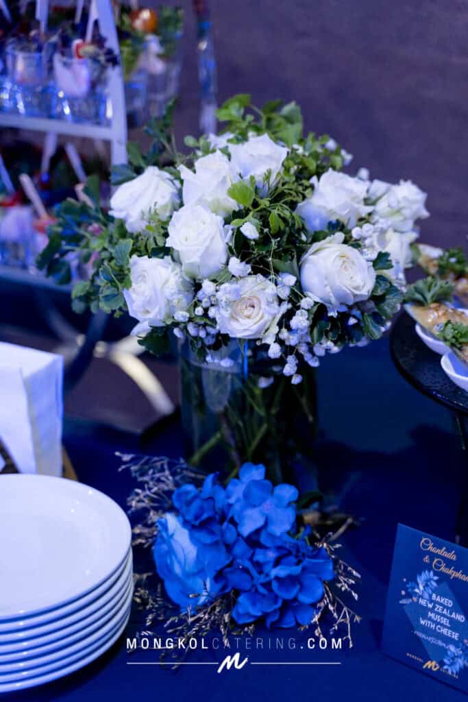 Elegant white rose floral centerpiece for Thai event catering in Thailand.