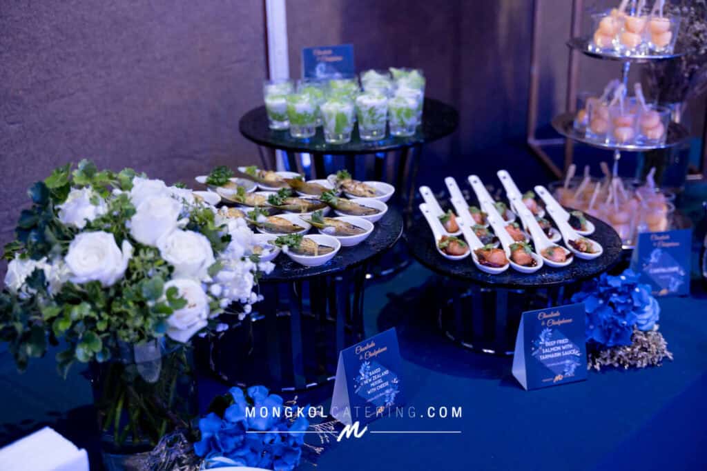 Elegant Thai catering display with seafood appetizers and floral decor for event in Thailand.