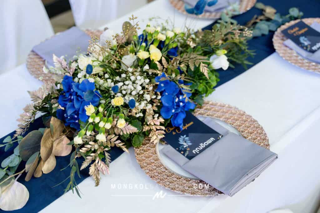 Elegant blue and white flower centerpiece for Thai event table decor.