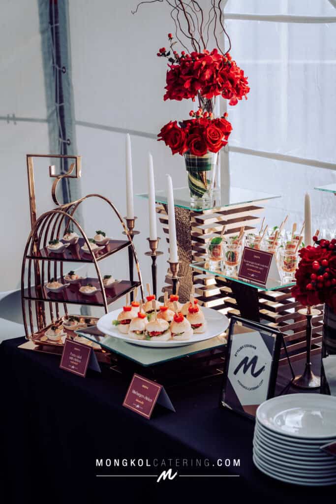 Elegant Thai event catering setup with floral arrangements and gourmet appetizers in Thailand.