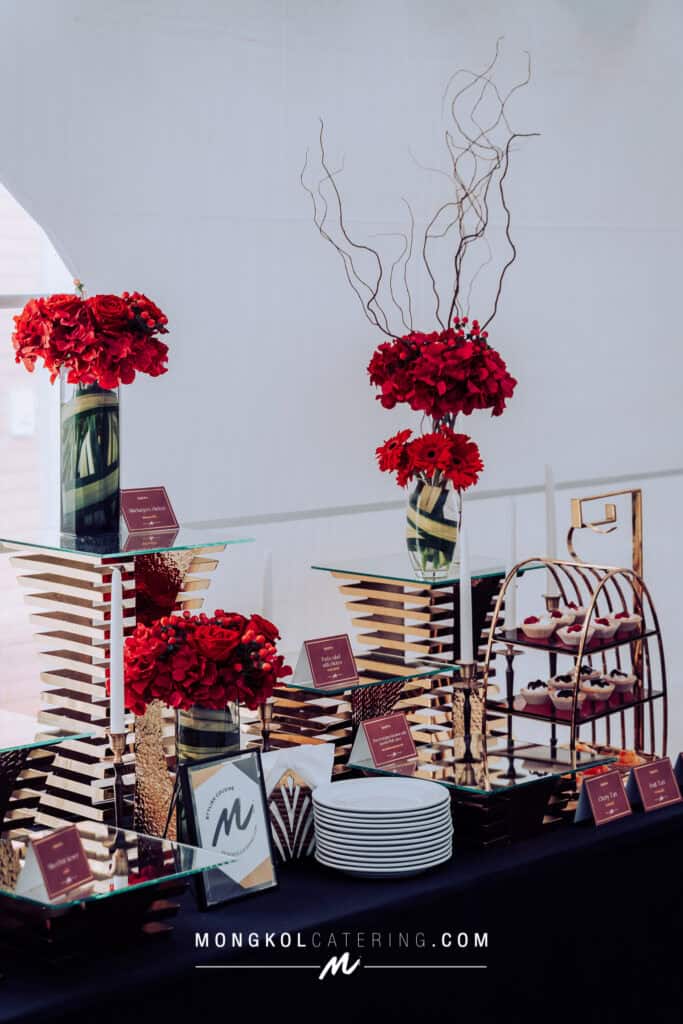 Elegant red floral arrangements for event catering in Thailand by Mongkol Catering.