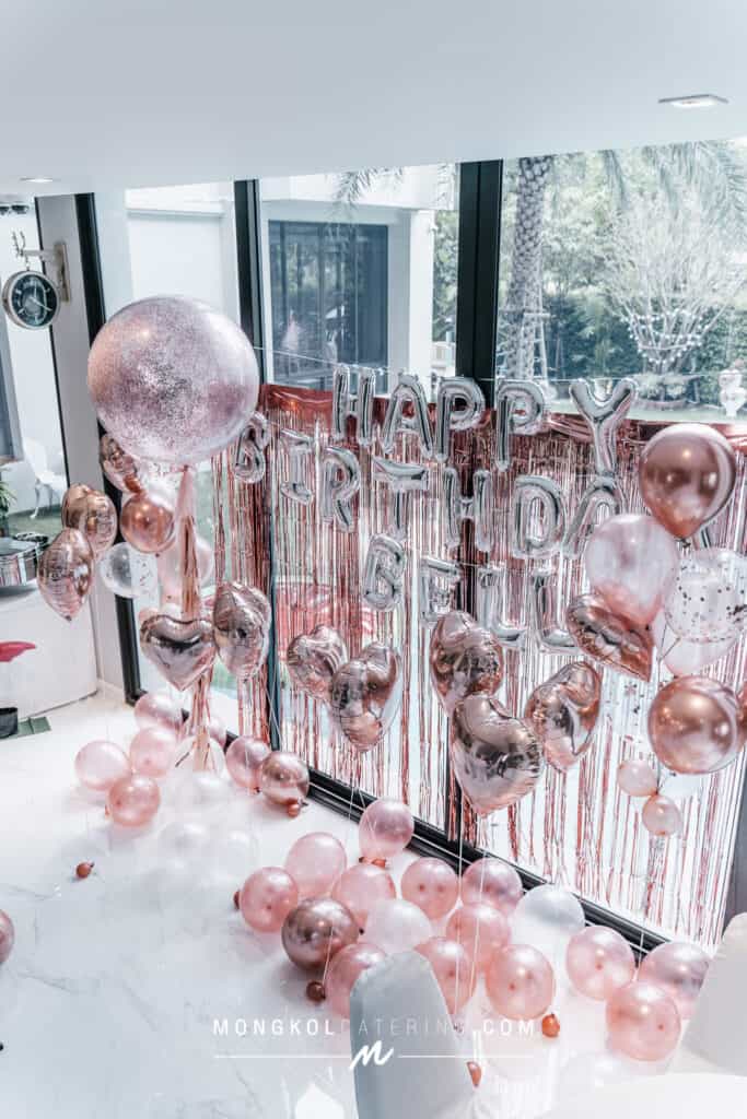 Balloon decoration with "Happy Birthday" banner in Thailand event venue.