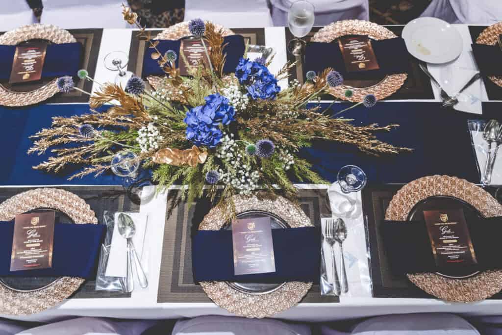 Elegant event table setup in Thailand with floral centerpiece by Mongkol Catering.