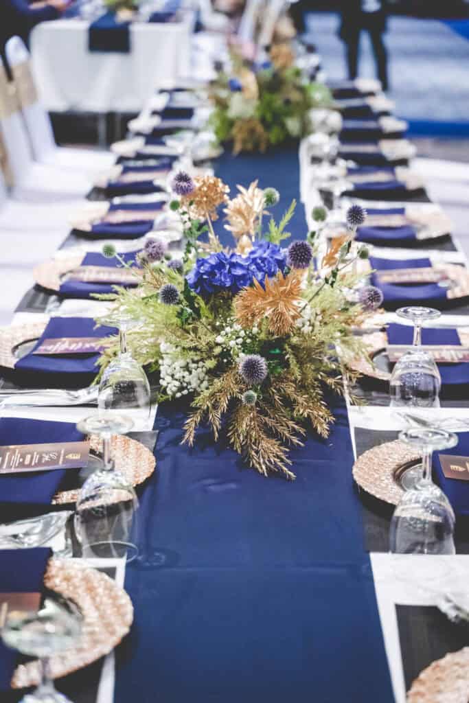 Elegant event table setup with floral centerpiece in Thailand.