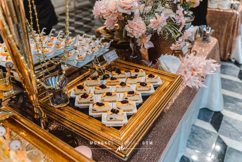 Delicious cheesecake squares with cherry topping displayed at Mongkol Catering event in Thailand.