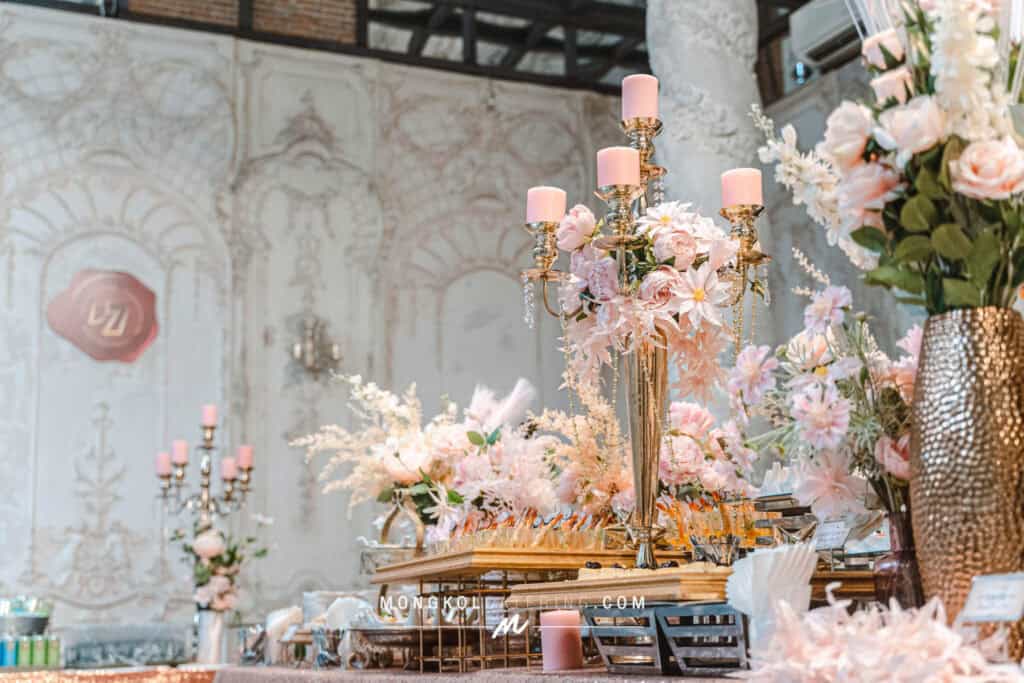 Elegant floral centerpiece with candle holders at Mongkol Catering event service in Thailand.