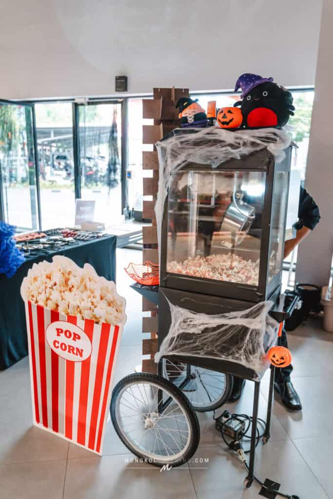 Colorful Halloween popcorn cart with spooky decorations in Thailand.
