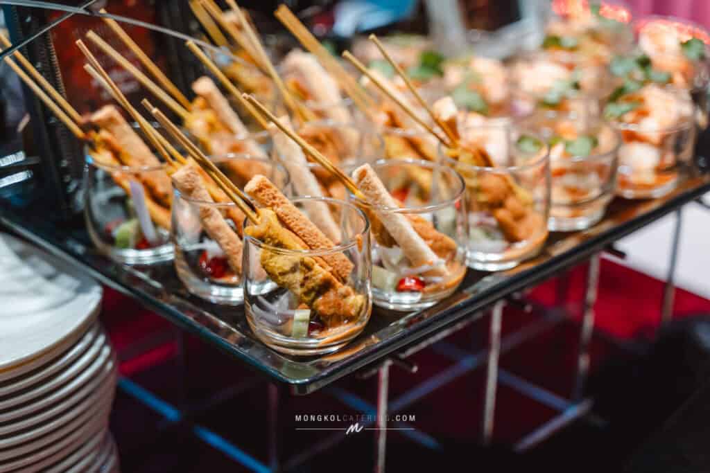 Skewered appetizers served in glasses at Mongkol Catering event in Thailand.