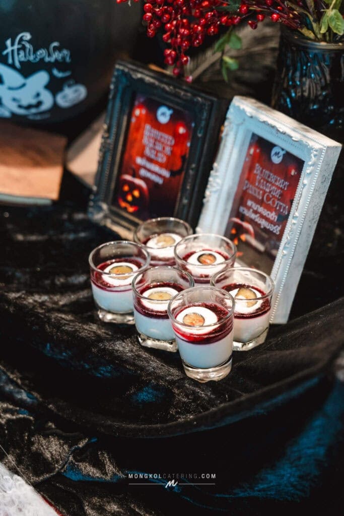 Festive Halloween-themed dessert glasses with yogurt and berry topping, showcased at Mongkol Catering events in Thailand.