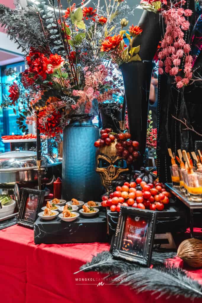 1. Elegant Halloween-themed floral table display in Thailand for Mongkol Catering event services.