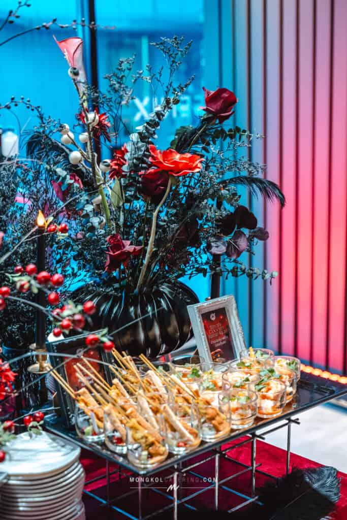 Colorful floral arrangement and appetizer display at a wedding reception in Thailand.