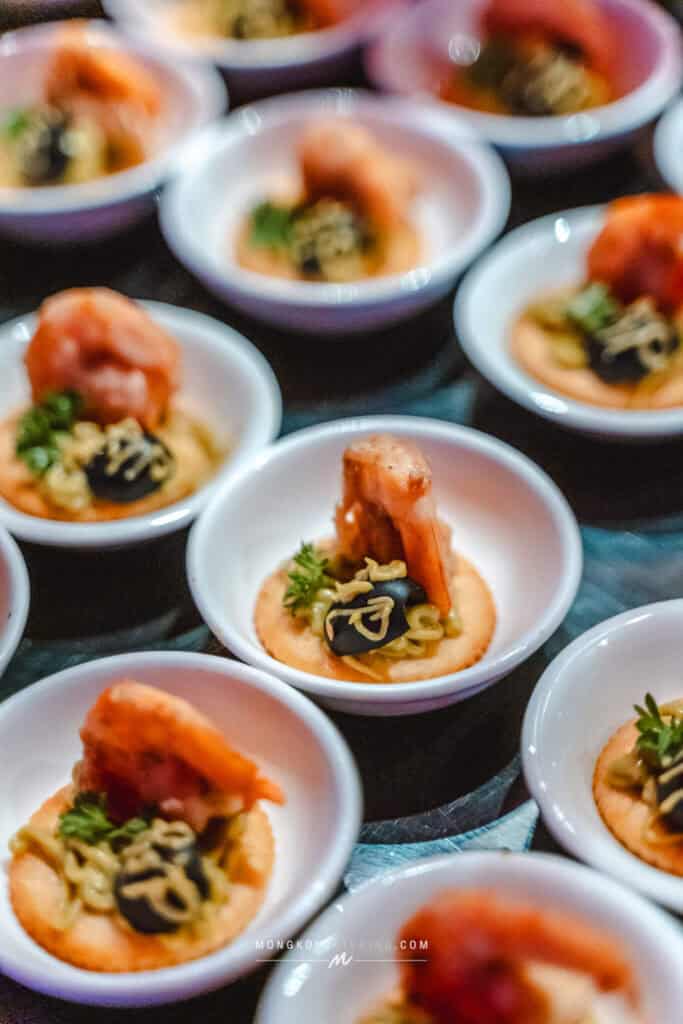 1. Small appetizers served in white bowls at Mongkol Catering event in Thailand.