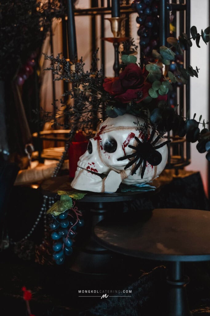 1. Spooky skull decoration with flowers and black accents for Halloween parties in Thailand.