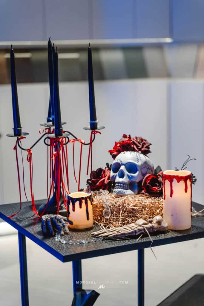 1. Elegant Halloween-themed table setup with skulls, candles, and dark decor in Thailand.