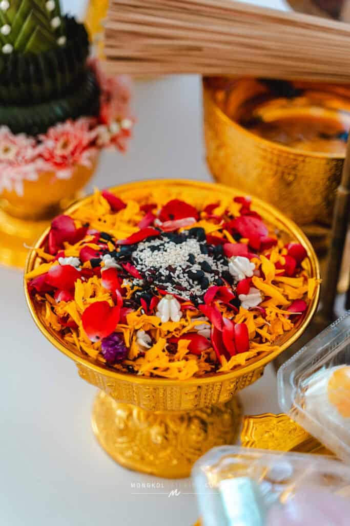 Colorful traditional Thai flower offering in a golden bowl for events and ceremonies in Thailand.