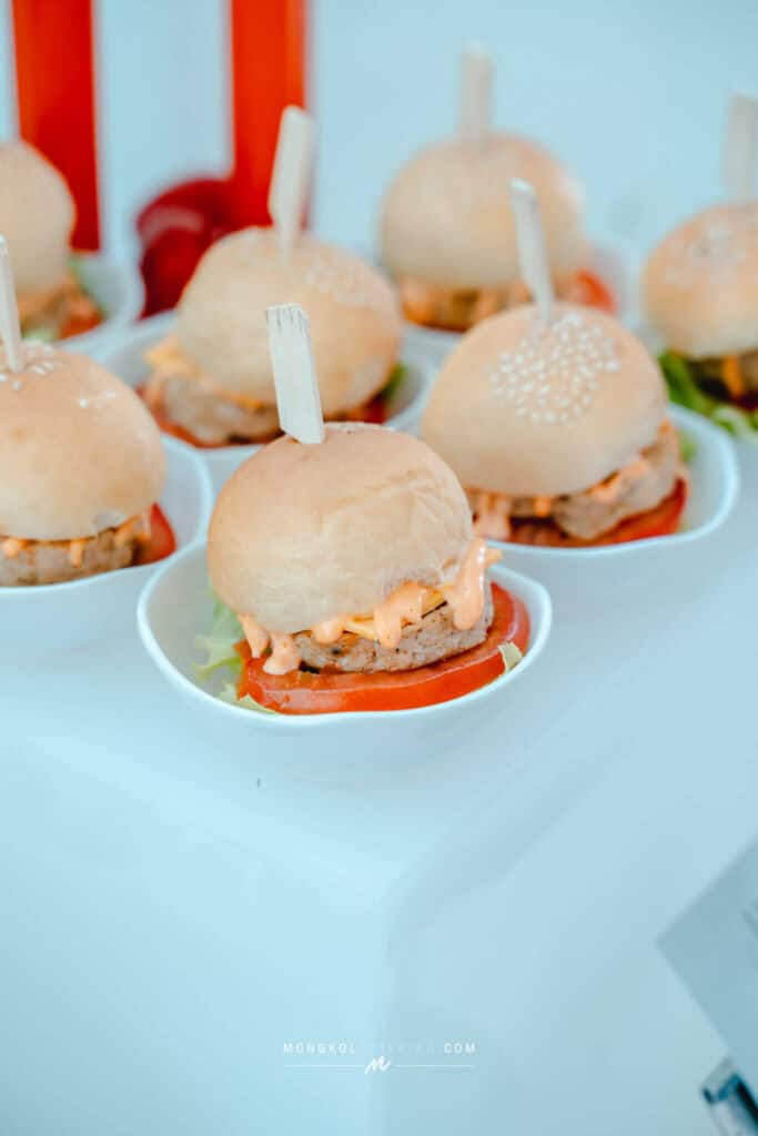 Mini burgers with lettuce and tomato at a catering event in Thailand.