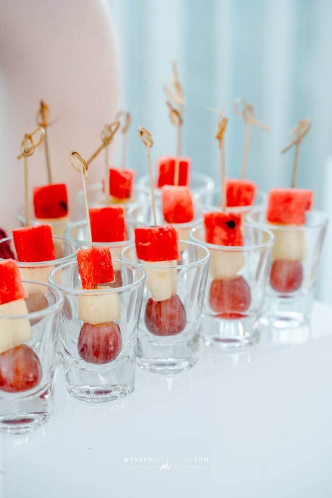 Colorful fruit skewers in glasses for special events in Thailand.