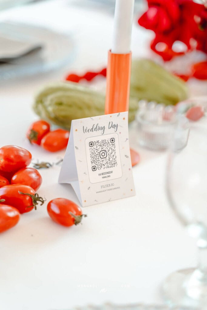 Colorful wedding table centerpiece featuring a QR code for guest interactions in Thailand.