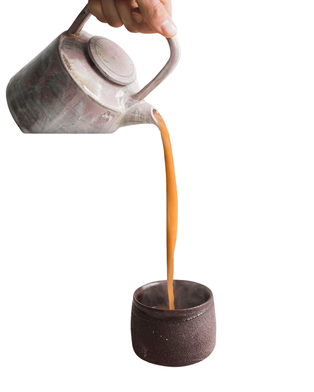 Hand pouring tea from a teapot into a cup